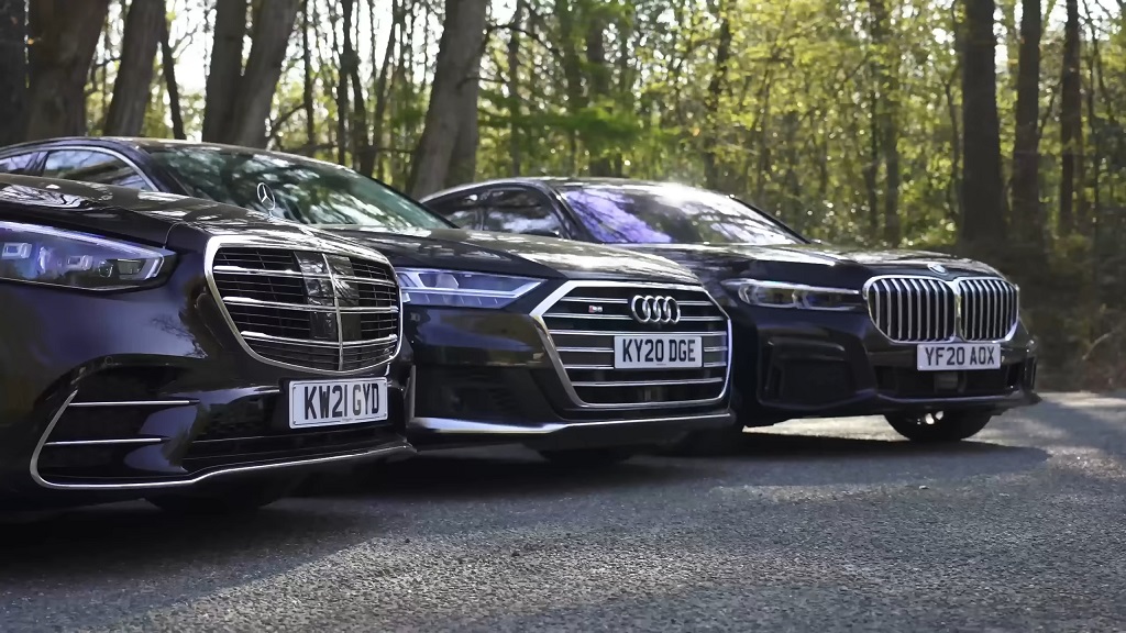 Front view of Mercedes-Benz, Audi, and BMW luxury sedans parked side by side for comparison